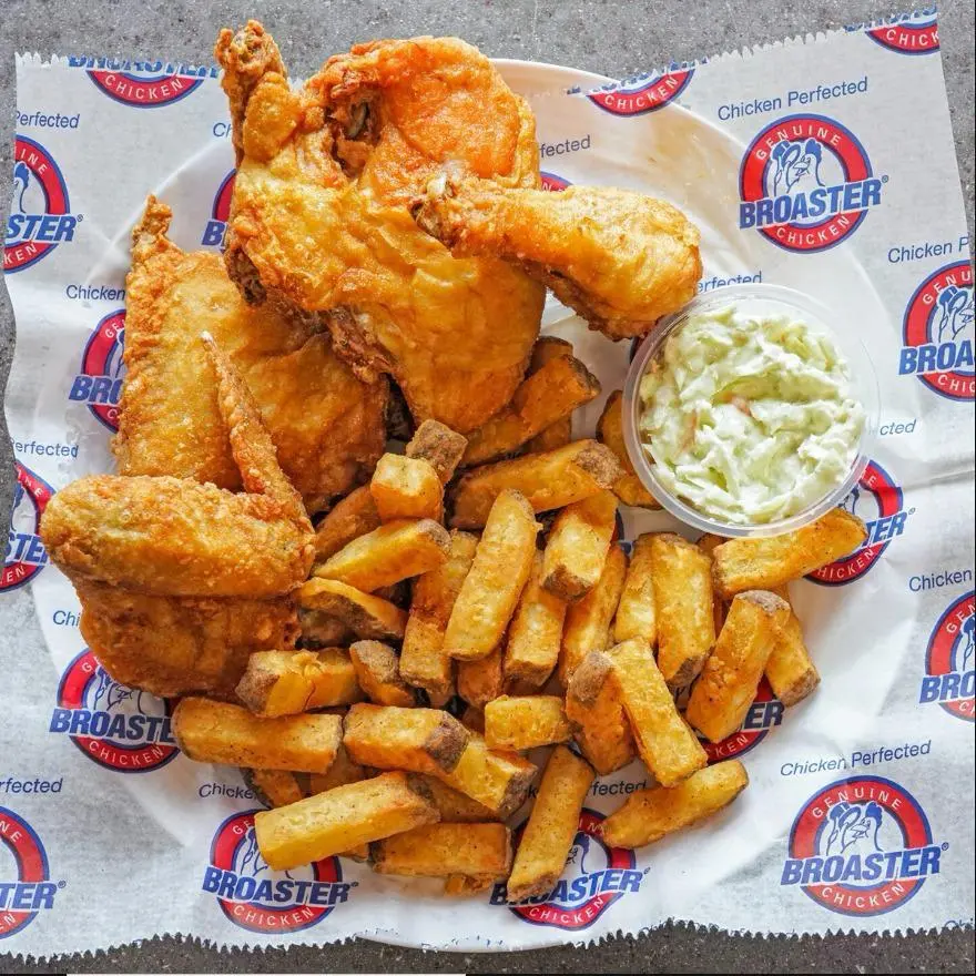 Broaster Chicken with fries and coleslaw on branded paper at Amean Edmonton